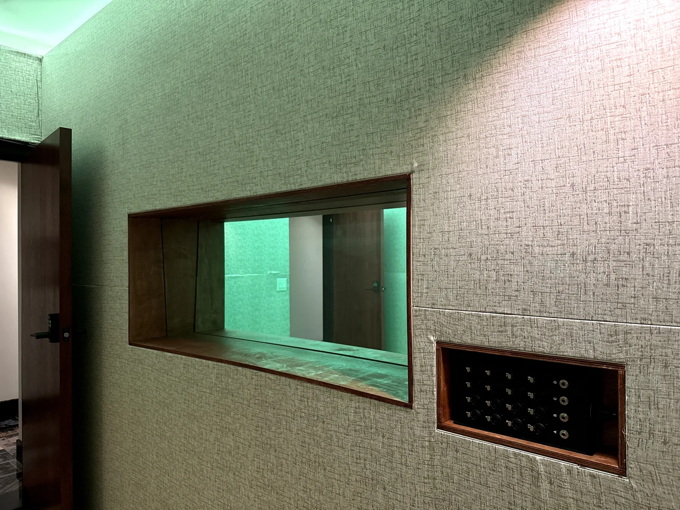 The window between a DTLA control room and live room, set into an acoustic wall