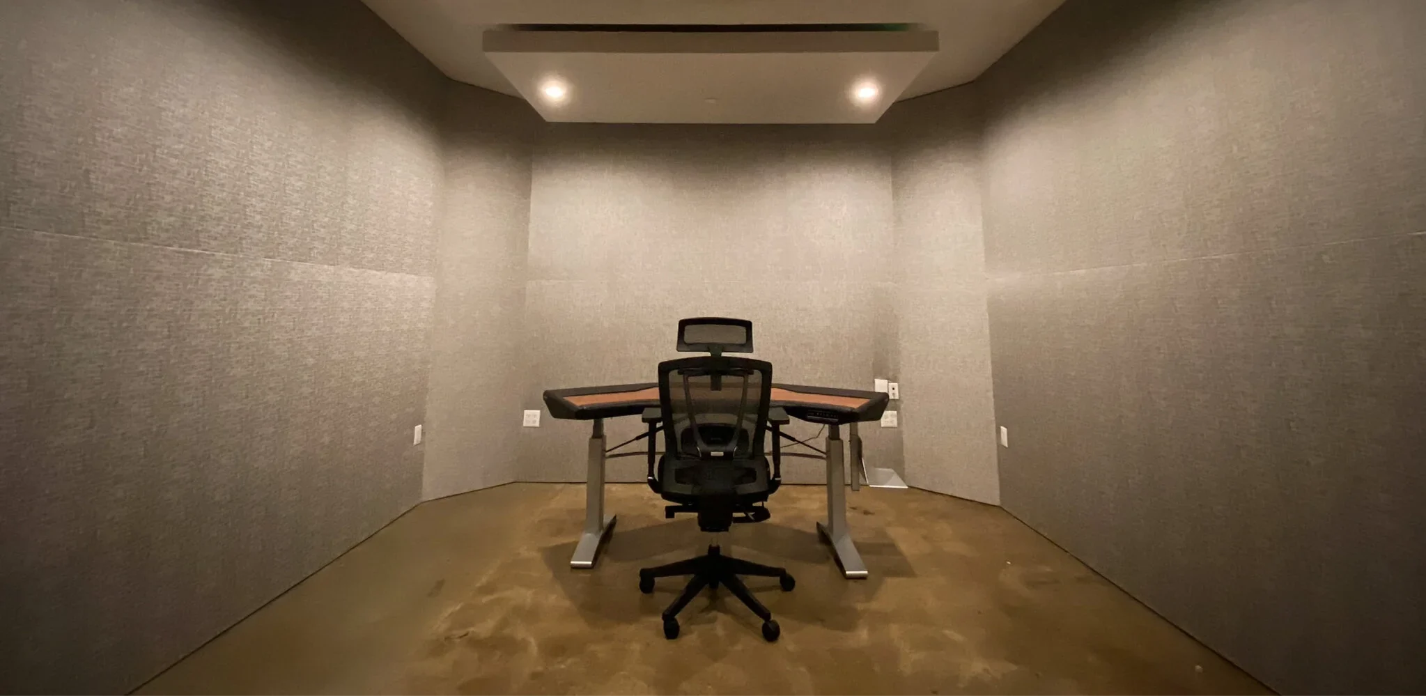 A Highland Park studio control room with fabric acoustic walls, a ceiling cloud, desk and chair