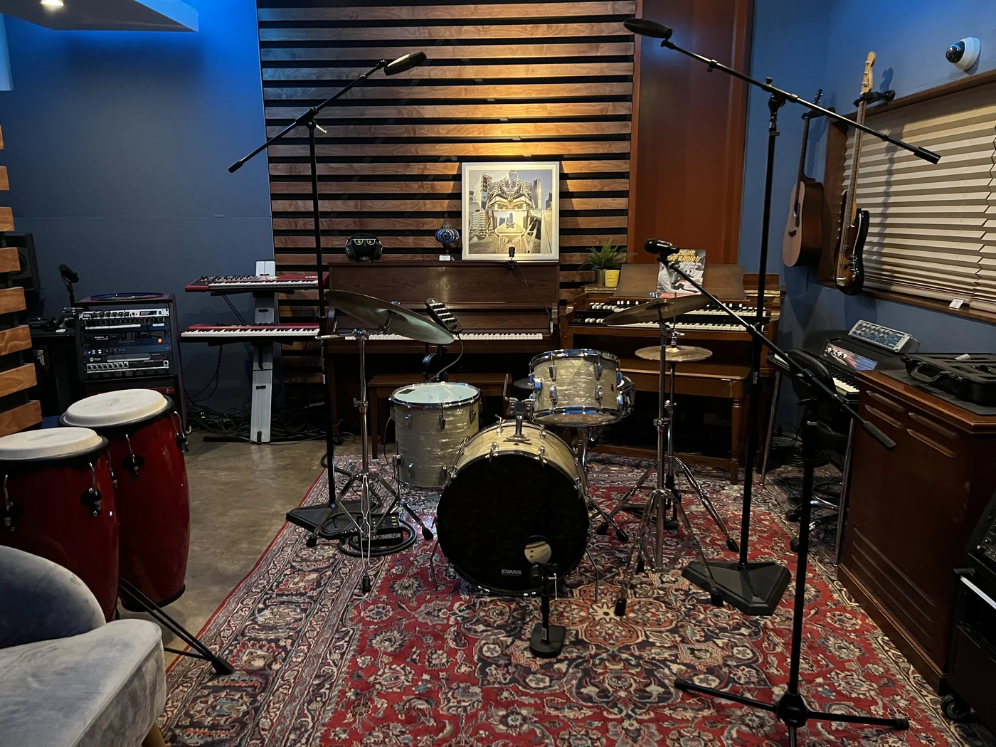 A LemonTree studio with a drum kit, piano, keyboards and wall-mounted guitars